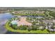 Aerial view of community clubhouse, pool, tennis courts, and lake at 16252 Amethyst Key Dr, Wimauma, FL 33598