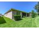 Landscaped backyard with a screened patio and lush lawn at 16252 Amethyst Key Dr, Wimauma, FL 33598
