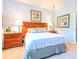 Spacious bedroom with a king-size bed, wood furniture and soft lighting at 16252 Amethyst Key Dr, Wimauma, FL 33598
