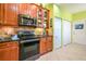 Well-equipped kitchen featuring wood cabinets and granite counters at 16252 Amethyst Key Dr, Wimauma, FL 33598