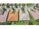 Aerial view of two homes with tile roofs in a residential community at 16252 Amethyst Key Dr, Wimauma, FL 33598