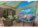 Outdoor patio with wicker furniture and shade sails, near pool at 16252 Amethyst Key Dr, Wimauma, FL 33598