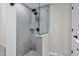 Updated shower with grey tile and glass enclosure at 2624 Society Dr, Holiday, FL 34691