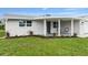 Charming ranch-style home with covered porch at 2624 Society Dr, Holiday, FL 34691