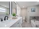 Modern bathroom with double vanity and soaking tub at 2624 Society Dr, Holiday, FL 34691