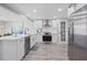 Modern kitchen with white cabinets, stainless steel appliances, and a large island at 2624 Society Dr, Holiday, FL 34691