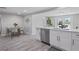 Modern kitchen with white cabinets, stainless steel dishwasher, and quartz countertops at 2624 Society Dr, Holiday, FL 34691
