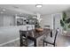 Modern dining room with a large table, gray chairs, and kitchen views at 2624 Society Dr, Holiday, FL 34691