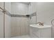 Updated bathroom with walk-in shower and pedestal sink at 2624 Society Dr, Holiday, FL 34691