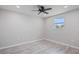 Simple bedroom with a window and wood-look floors at 2624 Society Dr, Holiday, FL 34691