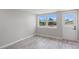 Light-filled bedroom with water views and wood-look floors at 2624 Society Dr, Holiday, FL 34691