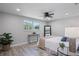 Bright bedroom with a queen bed, large window, and stylish decor at 2624 Society Dr, Holiday, FL 34691