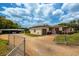 Front view of the home with gated driveway at 4902 N Habana Ave, Tampa, FL 33614