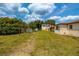 Large grassy backyard with a clothesline at 4902 N Habana Ave, Tampa, FL 33614