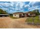 Side view of the home and gated driveway at 4902 N Habana Ave, Tampa, FL 33614
