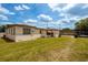 Tan single story home with a spacious yard at 4902 N Habana Ave, Tampa, FL 33614