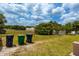 Large grassy backyard with trash cans at 4902 N Habana Ave, Tampa, FL 33614