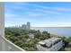 Scenic aerial view of lush green trees, city skyline, and blue ocean at 2910 W Barcelona St # 903, Tampa, FL 33629