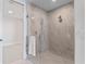 Modern bathroom with glass-enclosed shower and tile walls at 2910 W Barcelona St # 903, Tampa, FL 33629