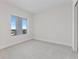 Cozy bedroom showcasing gray carpet, white walls, and views of city buildings through the window at 2910 W Barcelona St # 903, Tampa, FL 33629