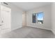 Bright bedroom featuring gray carpet and views of city buildings through the window at 2910 W Barcelona St # 903, Tampa, FL 33629