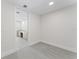 Empty Bonus room leading to bathroom with marble counters and flooring at 2910 W Barcelona St # 903, Tampa, FL 33629