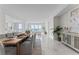 Open-concept dining area with seating for eight adjoins a modern living area with stunning waterfront views at 2910 W Barcelona St # 903, Tampa, FL 33629