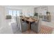 Spacious dining area with seating for eight features modern decor and an adjacent living area with waterfront views at 2910 W Barcelona St # 903, Tampa, FL 33629