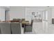 Dining room with seating for six, leading into the kitchen, and marble floors at 2910 W Barcelona St # 903, Tampa, FL 33629