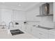 Bright kitchen featuring sleek white cabinetry, stainless steel appliances, and modern countertops at 2910 W Barcelona St # 903, Tampa, FL 33629