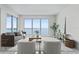 Cozy living room with plush seating and scenic water views from expansive windows, and sleek marble floors at 2910 W Barcelona St # 903, Tampa, FL 33629