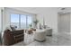 Bright living room features large windows with panoramic waterfront views and stylish contemporary furnishings at 2910 W Barcelona St # 903, Tampa, FL 33629