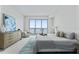 Bright main bedroom featuring an ocean view, dresser, and bedside table at 2910 W Barcelona St # 903, Tampa, FL 33629