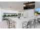 Outdoor bar and grilling area with marble counters and seating, perfect for entertaining guests at 2910 W Barcelona St # 903, Tampa, FL 33629
