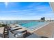 Rooftop pool deck with lounge chairs and ocean view on a sunny day at 2910 W Barcelona St # 903, Tampa, FL 33629