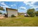 Spacious backyard showcasing grassy area and trees at 4904 N Habana Ave, Tampa, FL 33614