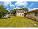Back exterior of house showcasing large grassy yard at 4904 N Habana Ave, Tampa, FL 33614