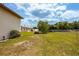 Large backyard with grassy area and covered vehicle at 4904 N Habana Ave, Tampa, FL 33614