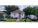 Front view of a charming house with a red roof and green lawn at 8003 N Klondyke St, Tampa, FL 33604