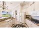 Spacious kitchen with granite countertops, white cabinets, and stainless steel appliances at 225 Pesaro Dr, North Venice, FL 34275