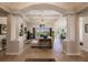 Spacious living room with high ceilings, chandelier, and access to backyard at 225 Pesaro Dr, North Venice, FL 34275