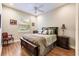Bright bedroom with a double bed, hardwood floors, and a window overlooking the backyard at 225 Pesaro Dr, North Venice, FL 34275