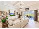 Living room with built-in shelving, comfortable seating, and views of the backyard at 225 Pesaro Dr, North Venice, FL 34275