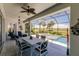 Relaxing screened-in patio with pool, hot tub, and golf course view at 225 Pesaro Dr, North Venice, FL 34275