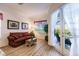 Bedroom sitting area with red sofa and access to the pool and patio at 225 Pesaro Dr, North Venice, FL 34275