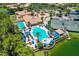Resort-style community pool with ample lounge chairs and tennis courts at 225 Pesaro Dr, North Venice, FL 34275