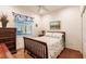Charming bedroom with a double bed, hardwood floors, and a view of the backyard at 225 Pesaro Dr, North Venice, FL 34275