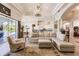 Open concept living area with large windows, a comfortable seating area, and views of the golf course at 225 Pesaro Dr, North Venice, FL 34275
