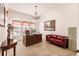 Home office with a large desk, comfortable seating, and natural light at 225 Pesaro Dr, North Venice, FL 34275