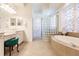 Luxurious bathroom with a large soaking tub, double vanity and glass block shower at 225 Pesaro Dr, North Venice, FL 34275